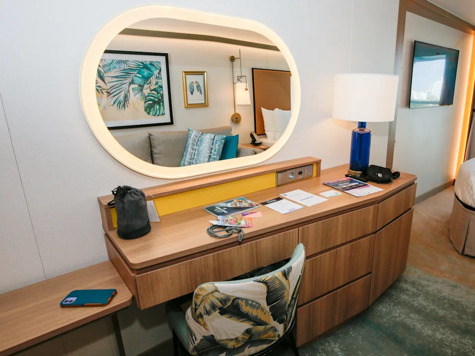 Cluttered hotel room vanity with poor lighting